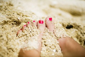 girl feet in sand